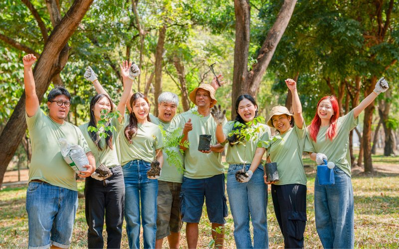 A group of volunteers holding seedlings